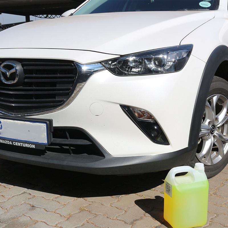 Car wash shampoo in front of a car