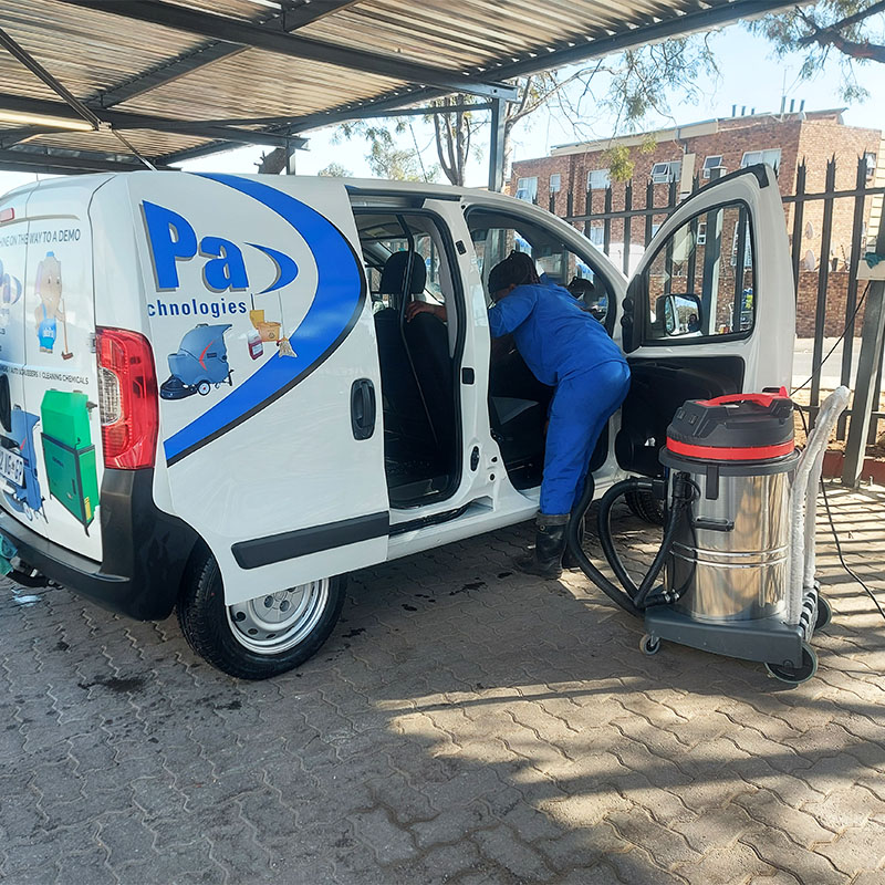 Person Vacuuming inside a company vehicle